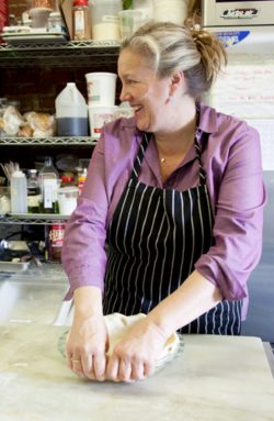 Little Flower Recipes cookbook, woman in purple top and striped apron preparing food