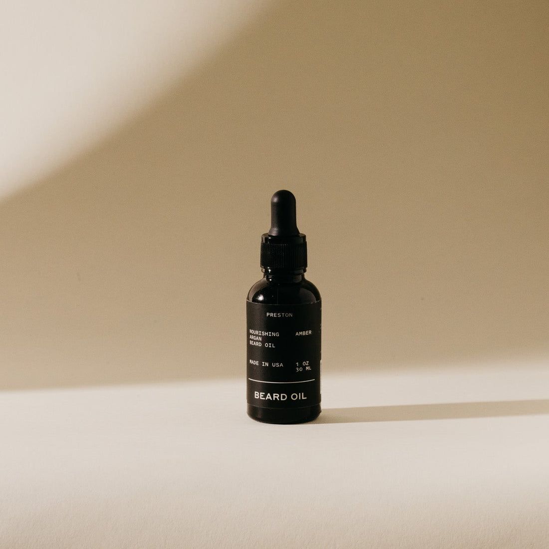 Amber beard oil bottle with black dropper cap, 1 oz