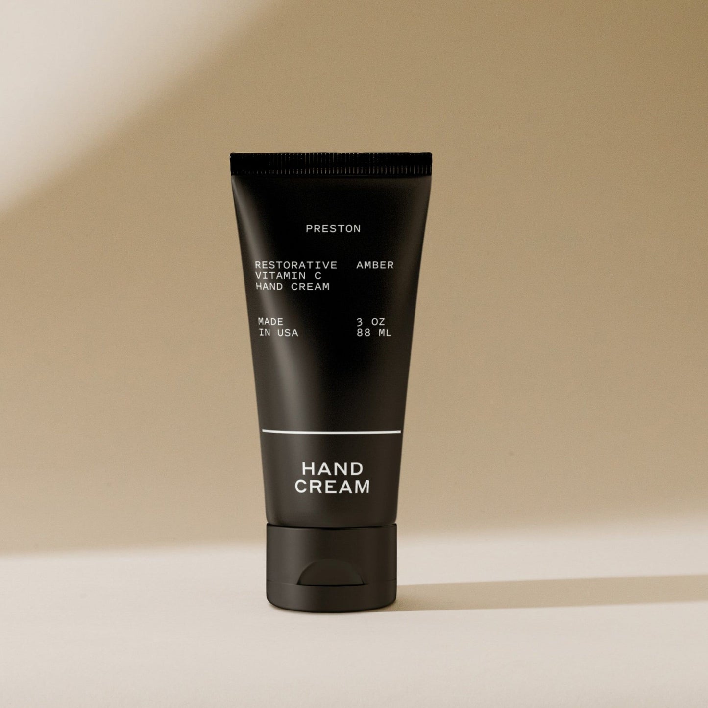 Amber hand cream in black squeeze tube, 3 oz (88 mL)
