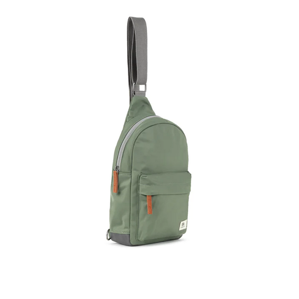 Sage green sling bag with adjustable strap, front pocket detail, and metal hardware