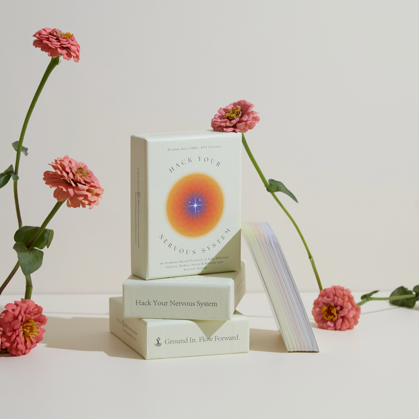 Card deck in light box with colorful circular energy artwork on card fronts.