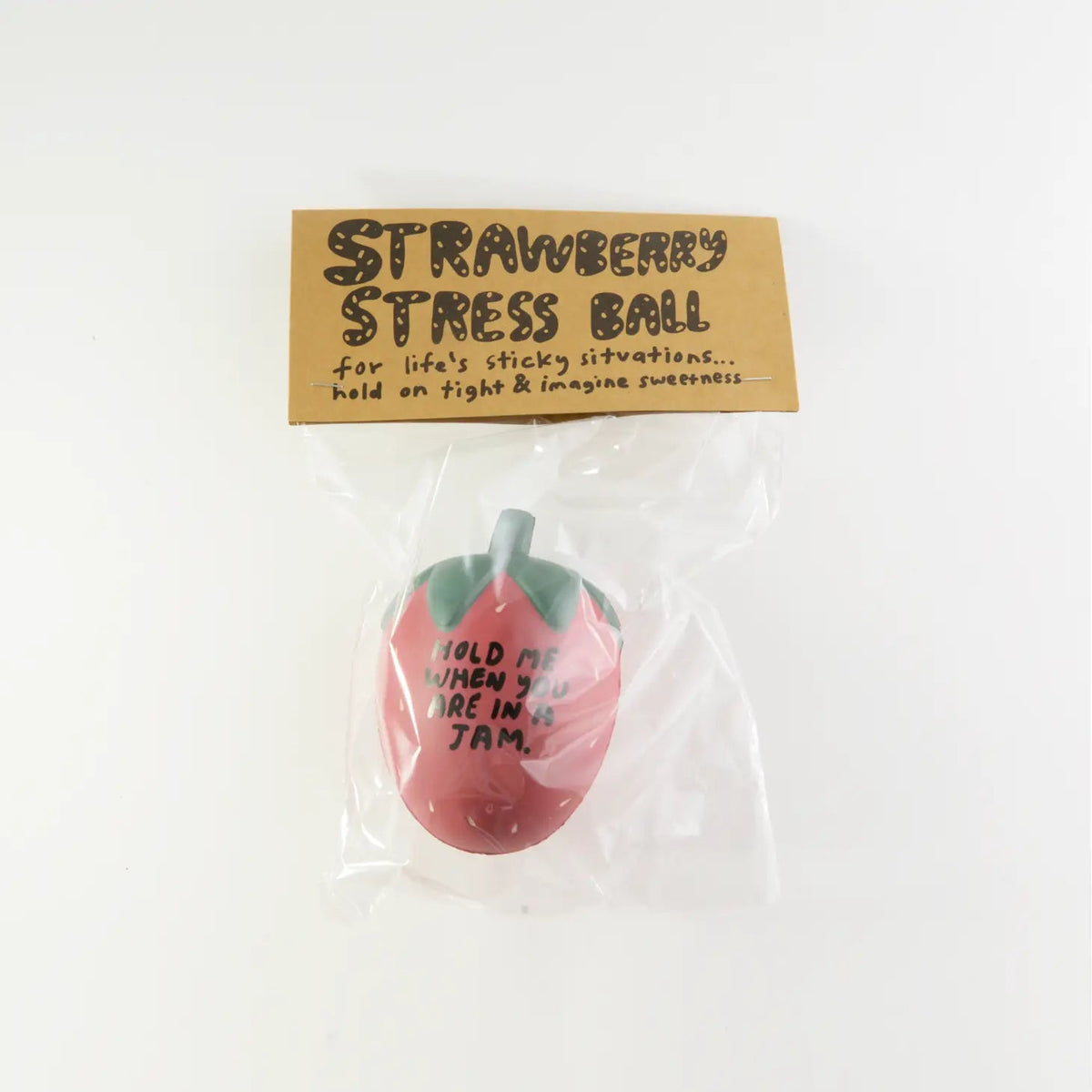 Red strawberry-shaped stress ball with green leaves and printed message on front