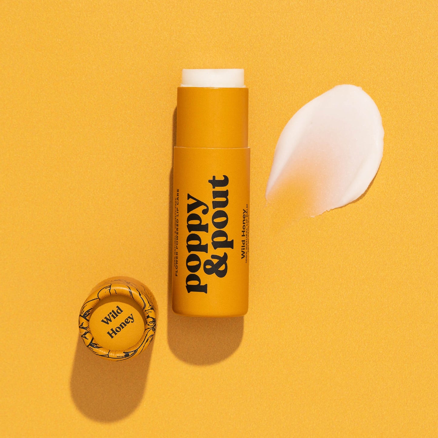 Wild honey lip balm tube with cap and white balm swatch