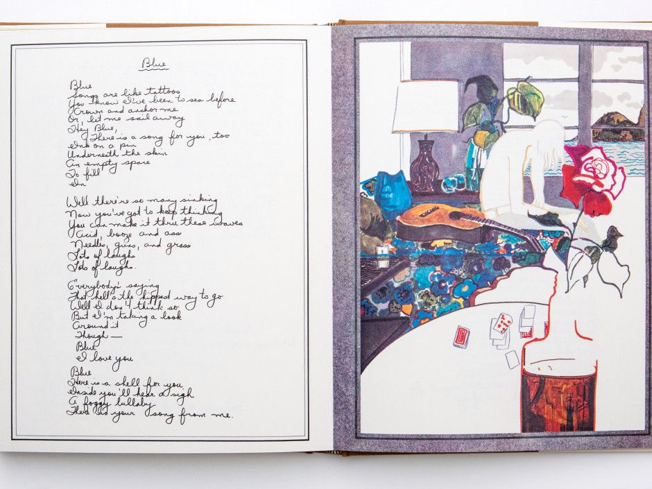 Open lyrics book with handwritten poem on left and colorful scene illustration on right