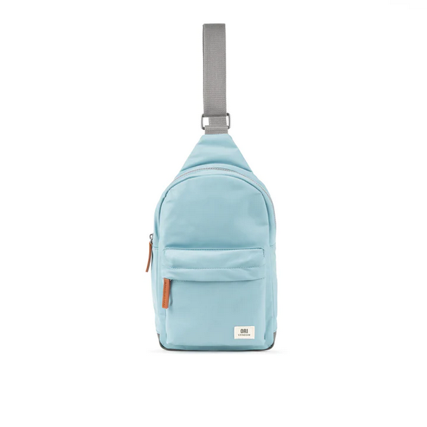 Large light blue recycled nylon sling bag with adjustable strap and front zip pocket