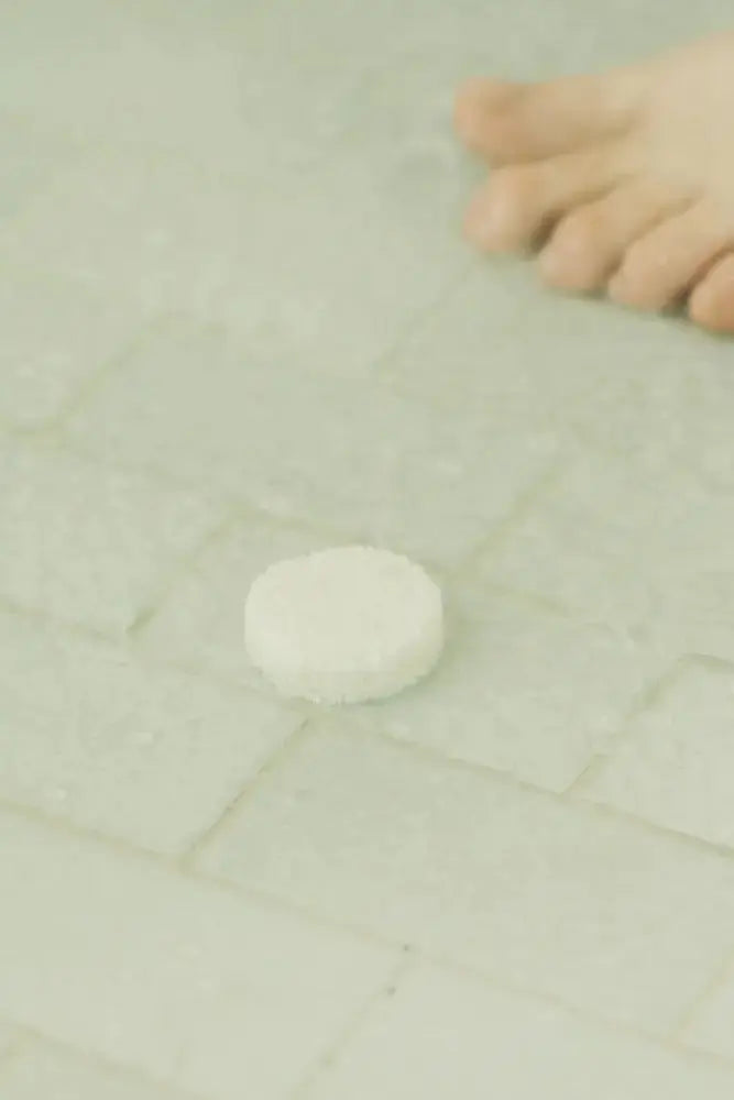 Eucalyptus Steam wax melt, small white round on light tile surface