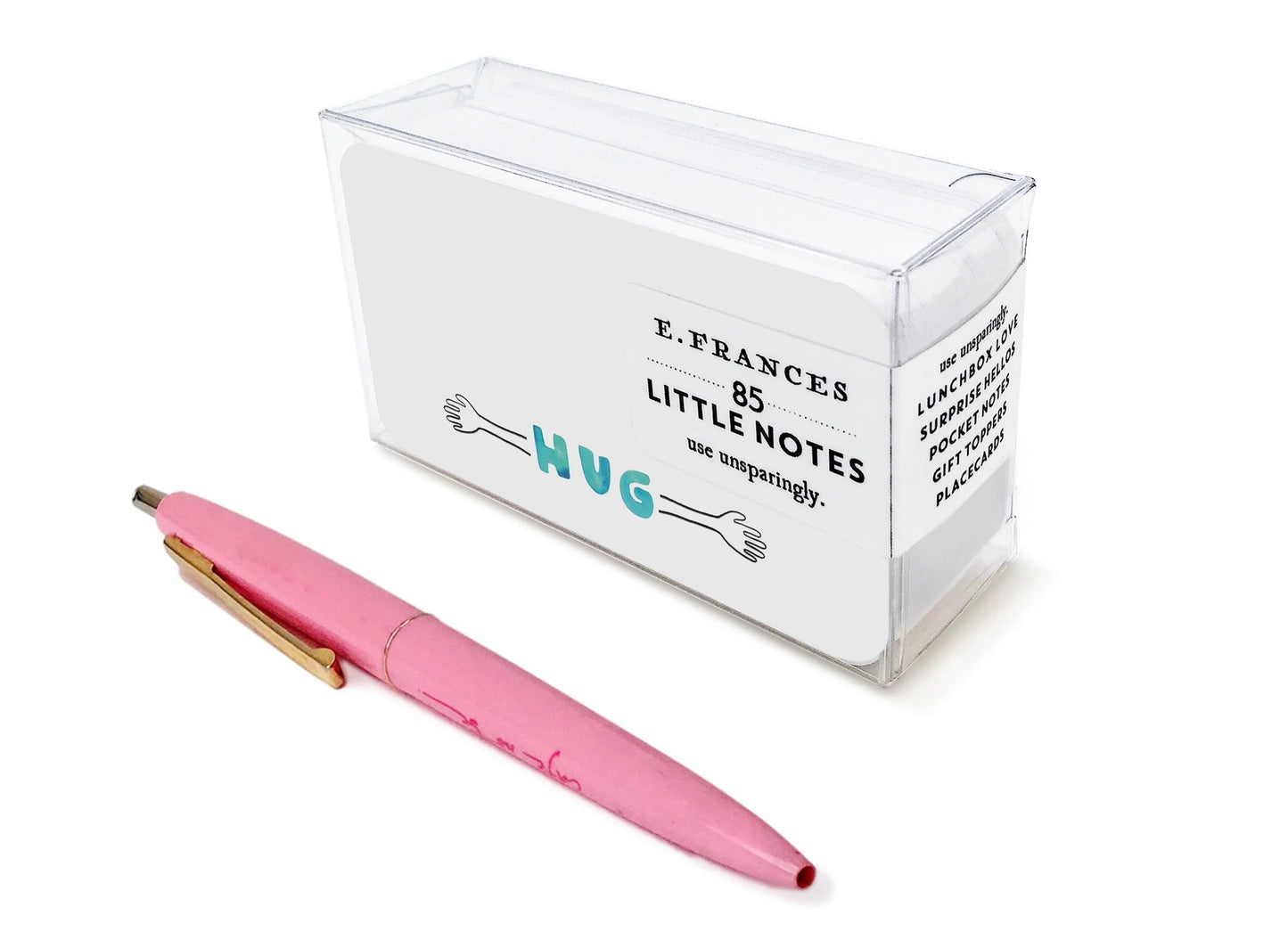 Transparent note box with teal 'HUG' label, pink pen beside it