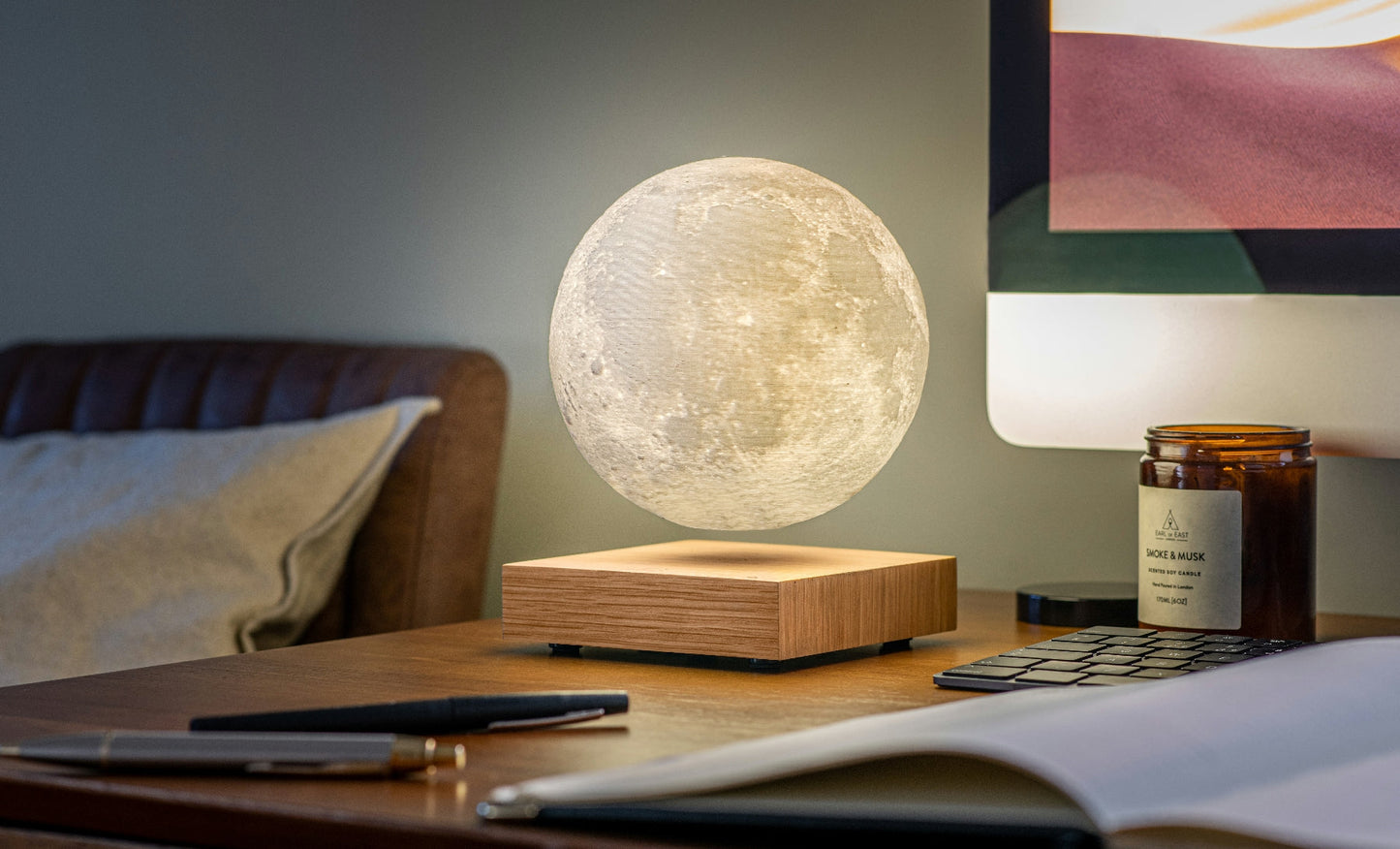 Moon lamp with glowing frosted sphere on light wood base