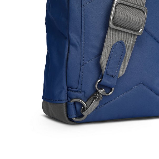 Burnt blue recycled nylon sling bag with metal D-ring strap hardware and stitched seams