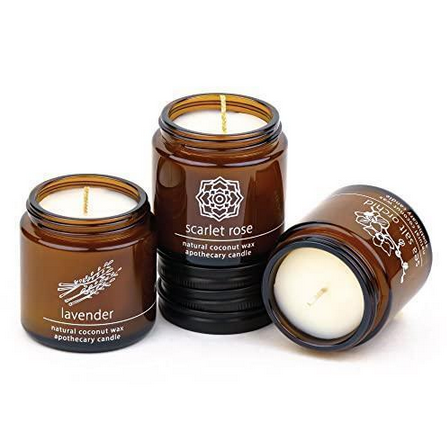 Amber glass coconut wax candle jars with wicks, labeled Lavender, Scarlet Rose, Palo Santo