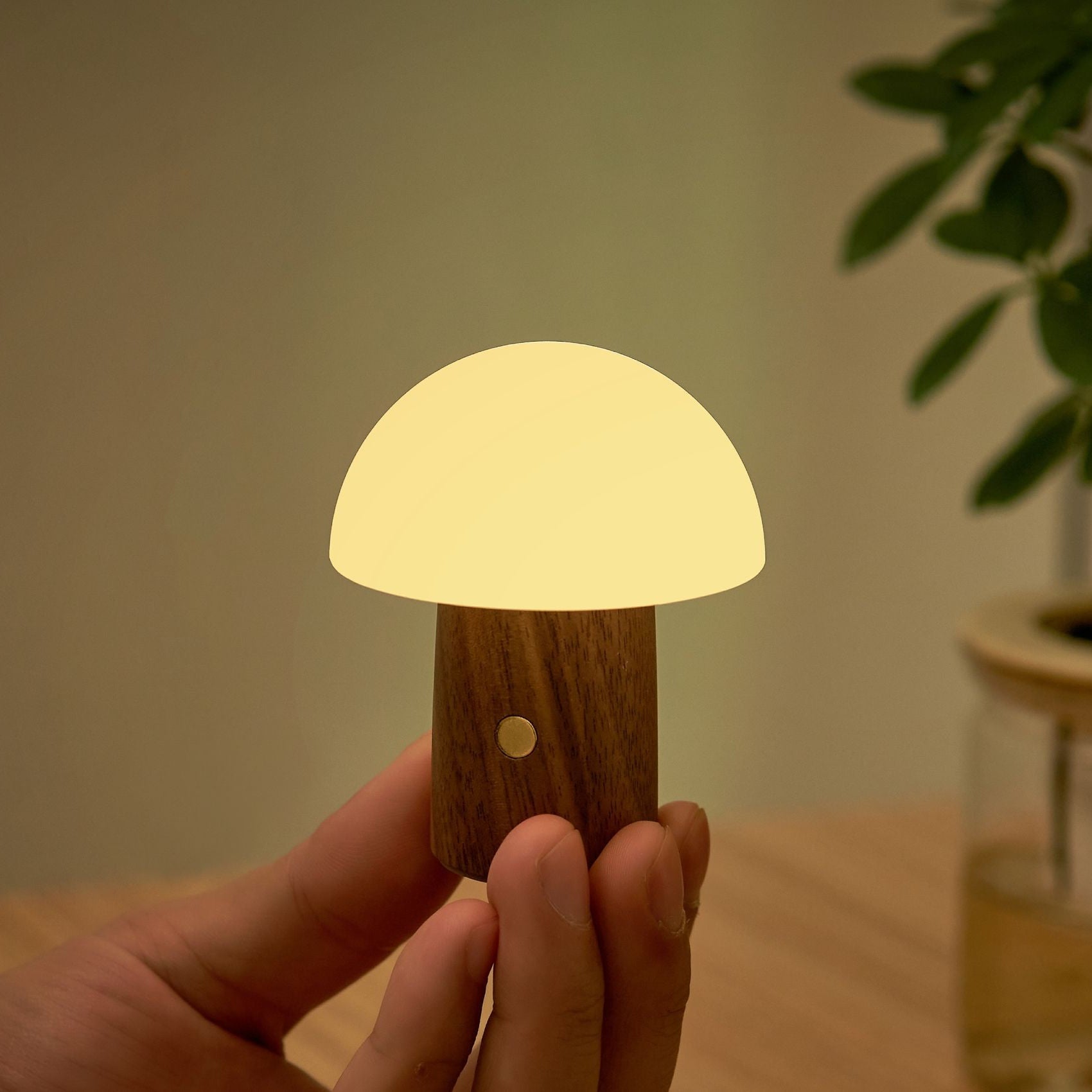 Super mini walnut mushroom lamp with glowing white cap and round hole on stem