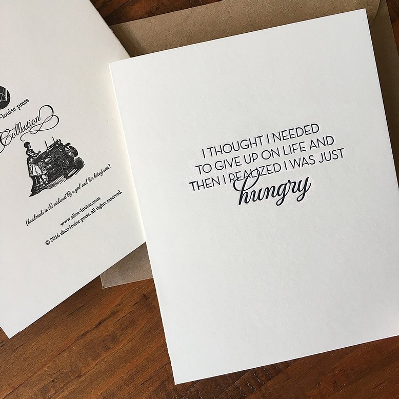 White greeting card featuring "hungry" in script with motivational quote