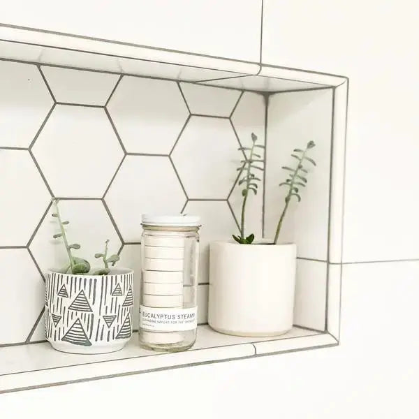 Eucalyptus Steam scented wax jar on a shelf display, clear glass with white lid