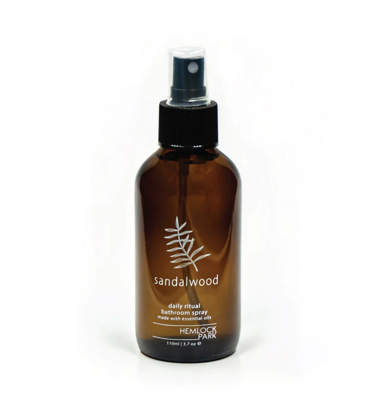 Room spray bottle with sandalwood label, amber glass, black mist nozzle and cap