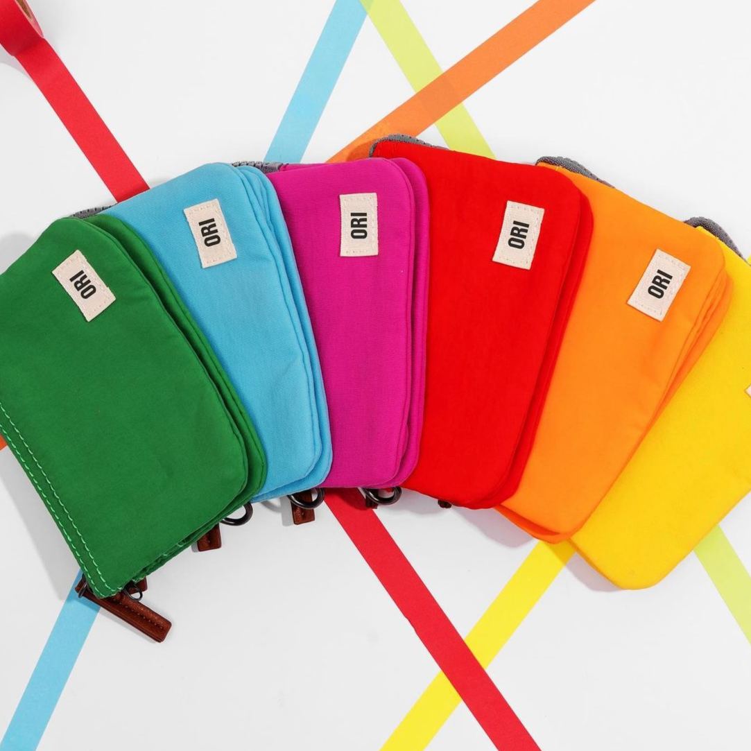 Assorted small recycled canvas zipper pouches in green, blue, pink, red, orange