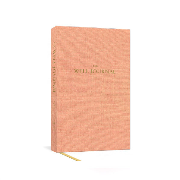 Orange hardcover notebook journal with bookmark ribbon and The Well Journal title on cover
