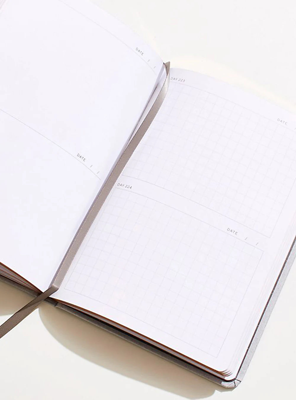 Open sketch diary with lined monthly-style pages and date boxes