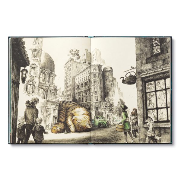 Hardcover book opened to detailed monochrome town scene with cat and people