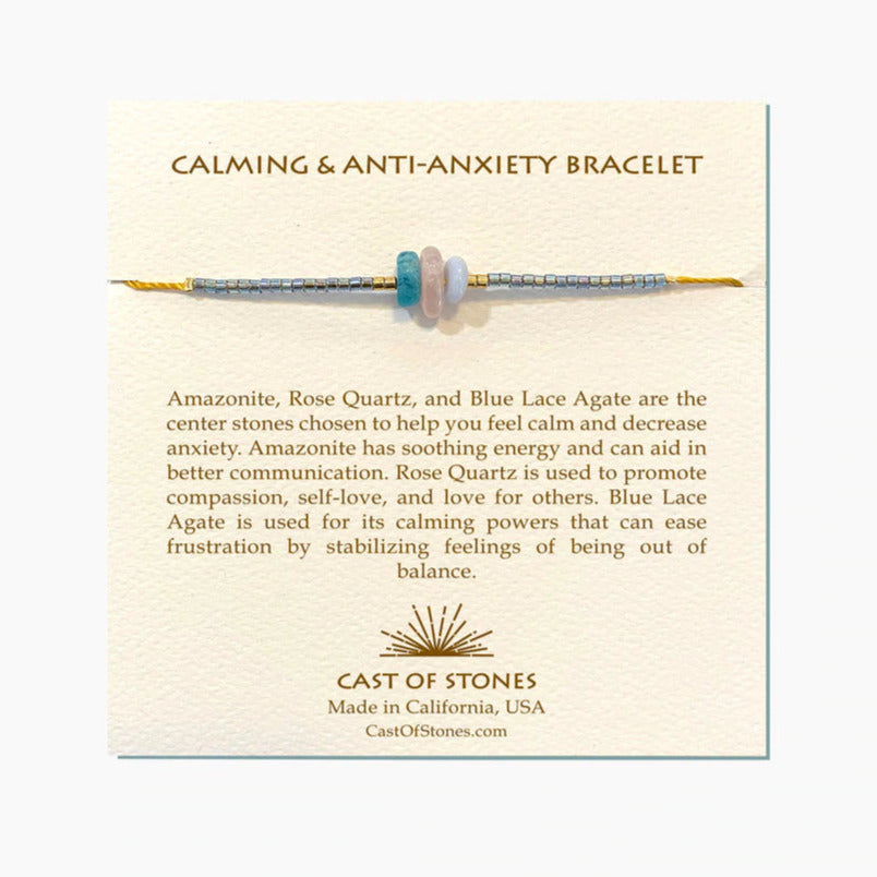 Beaded gemstone bracelet with light blue beads and a purple center spacer