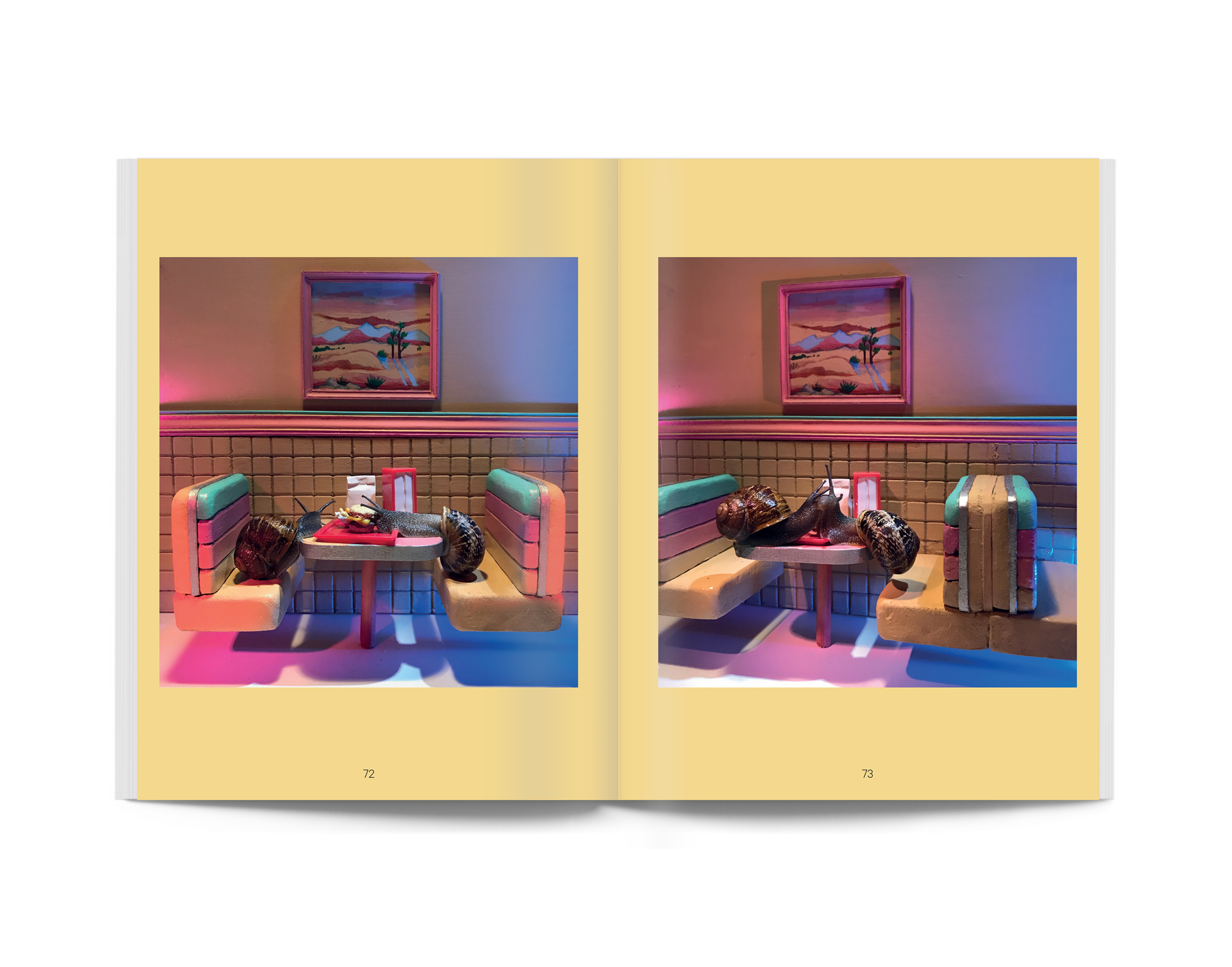 Open paperback spread with two photos of snails beside a blue table and chairs