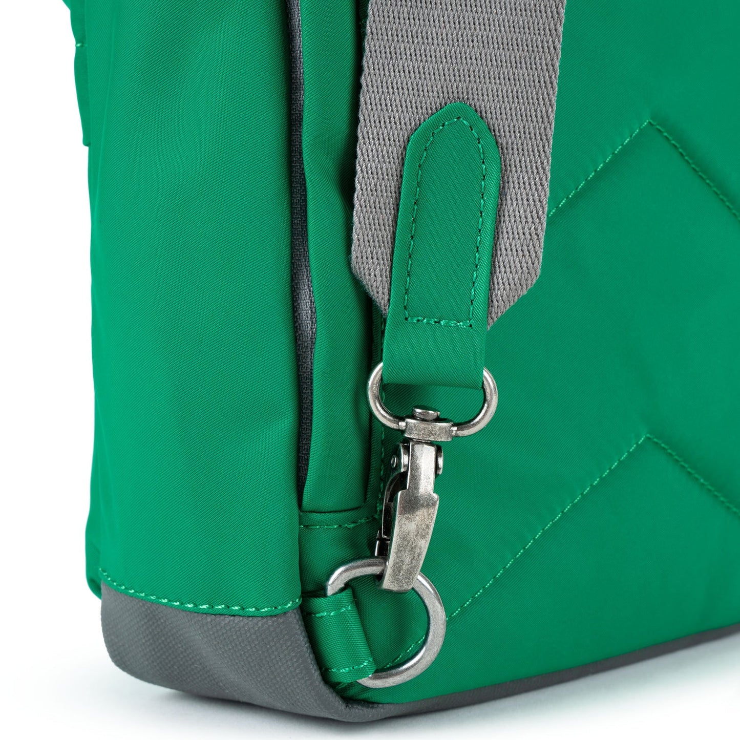 Green recycled nylon sling bag with metal D-ring on gray strap and stitched details