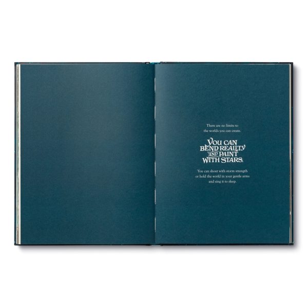 Hardcover book opened to teal pages with centered quote text