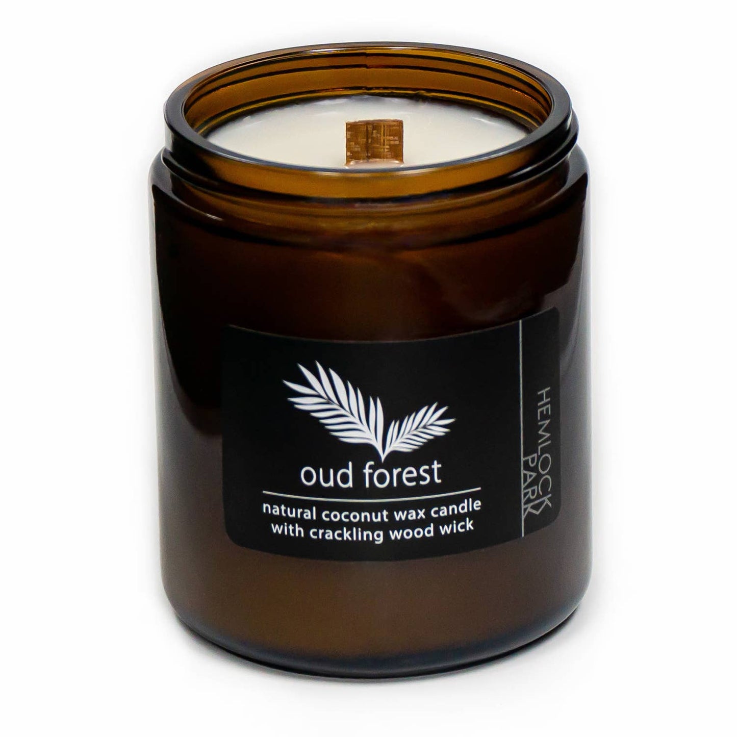 Coconut wax candle in amber jar with wood wick, oud forest scent label