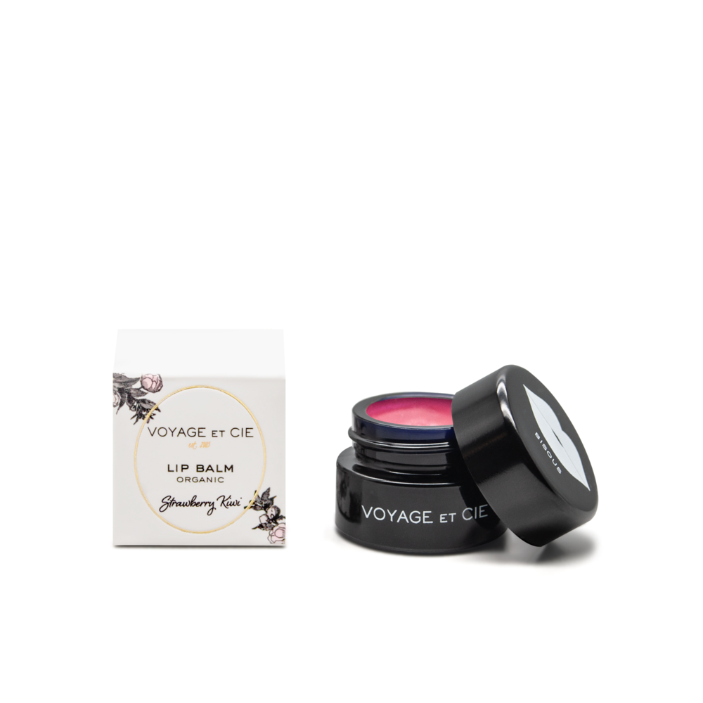 Organic lip balm jar, open lid showing pink balm; Strawberry Kiwi flavor