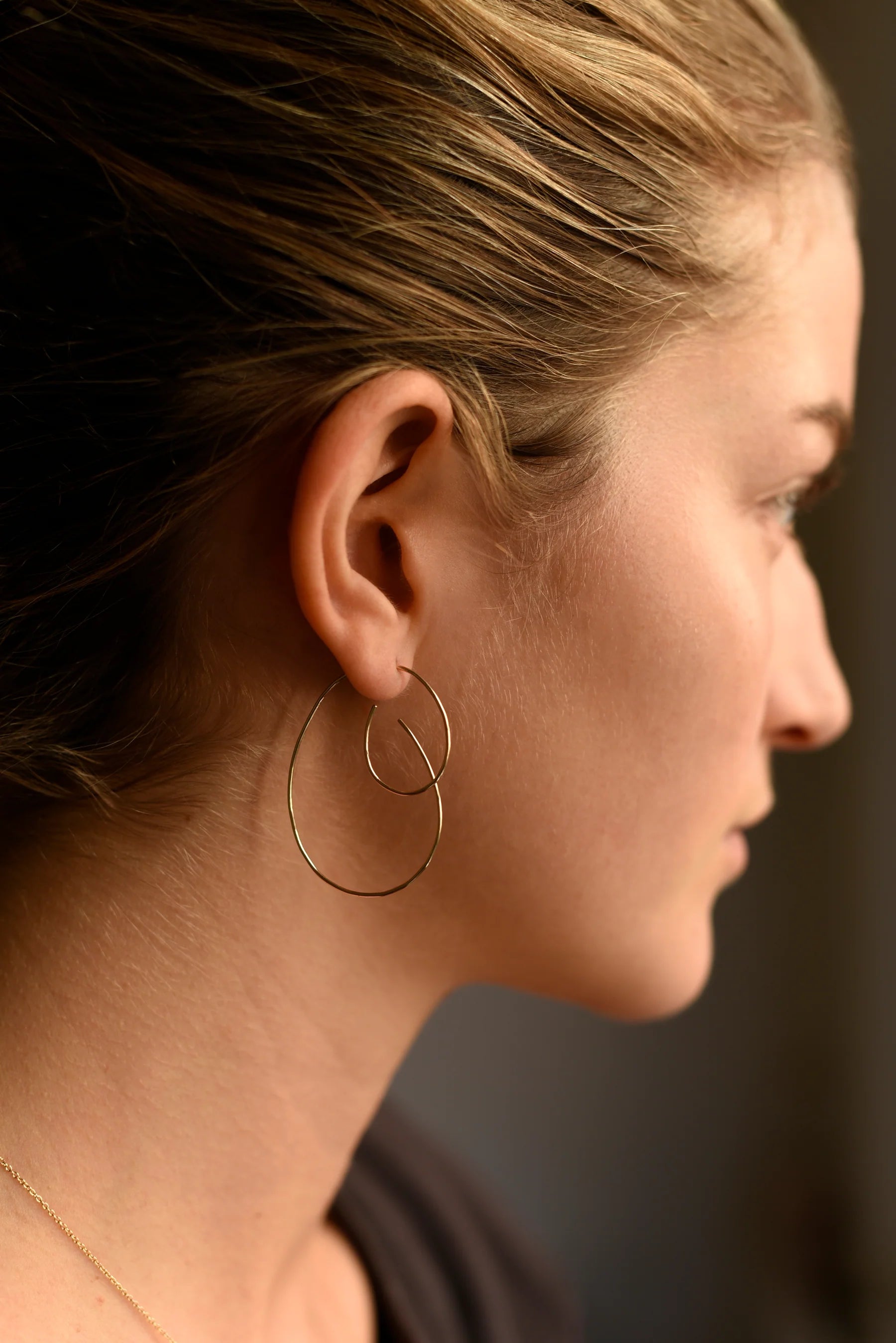 Large hoop threader earrings with curved hook, shown on ear profile