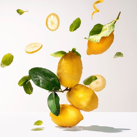 Citron hand and nail cream theme with lemon halves, citrus slices, and green leaves