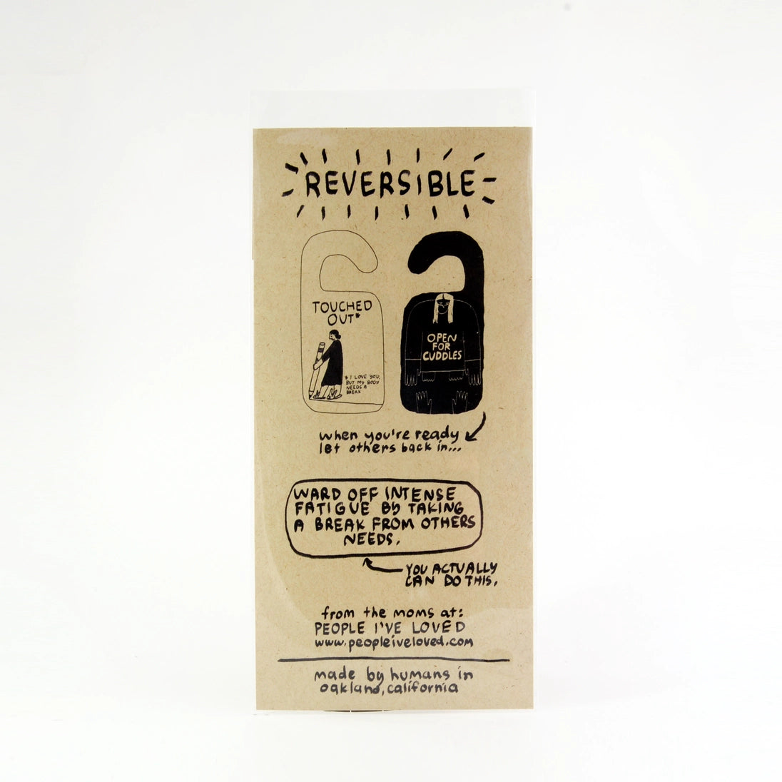 Reversible door hanger face with 'Reversible' label and handwritten-style text