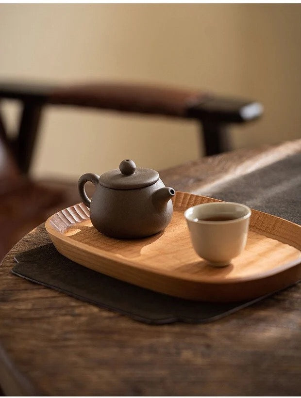 Wooden tea tray with carved edge and textured surface, serving tray for teapot and cup