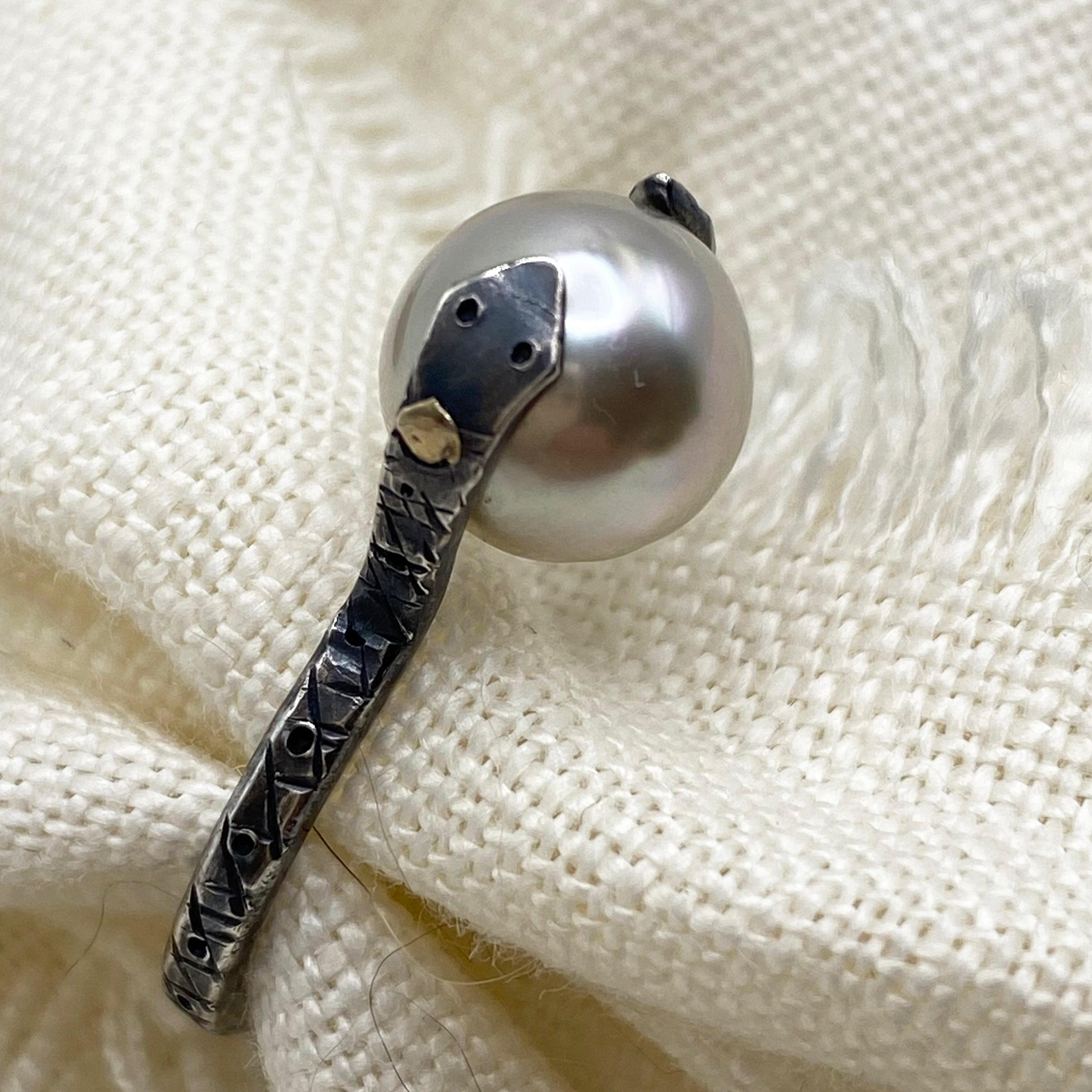 Sterling silver snake ring with large iridescent Tahitian pearl, dark textured band