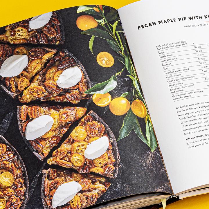 Cookbook open to Pecan Maple Pie page with ingredient list and pie photo