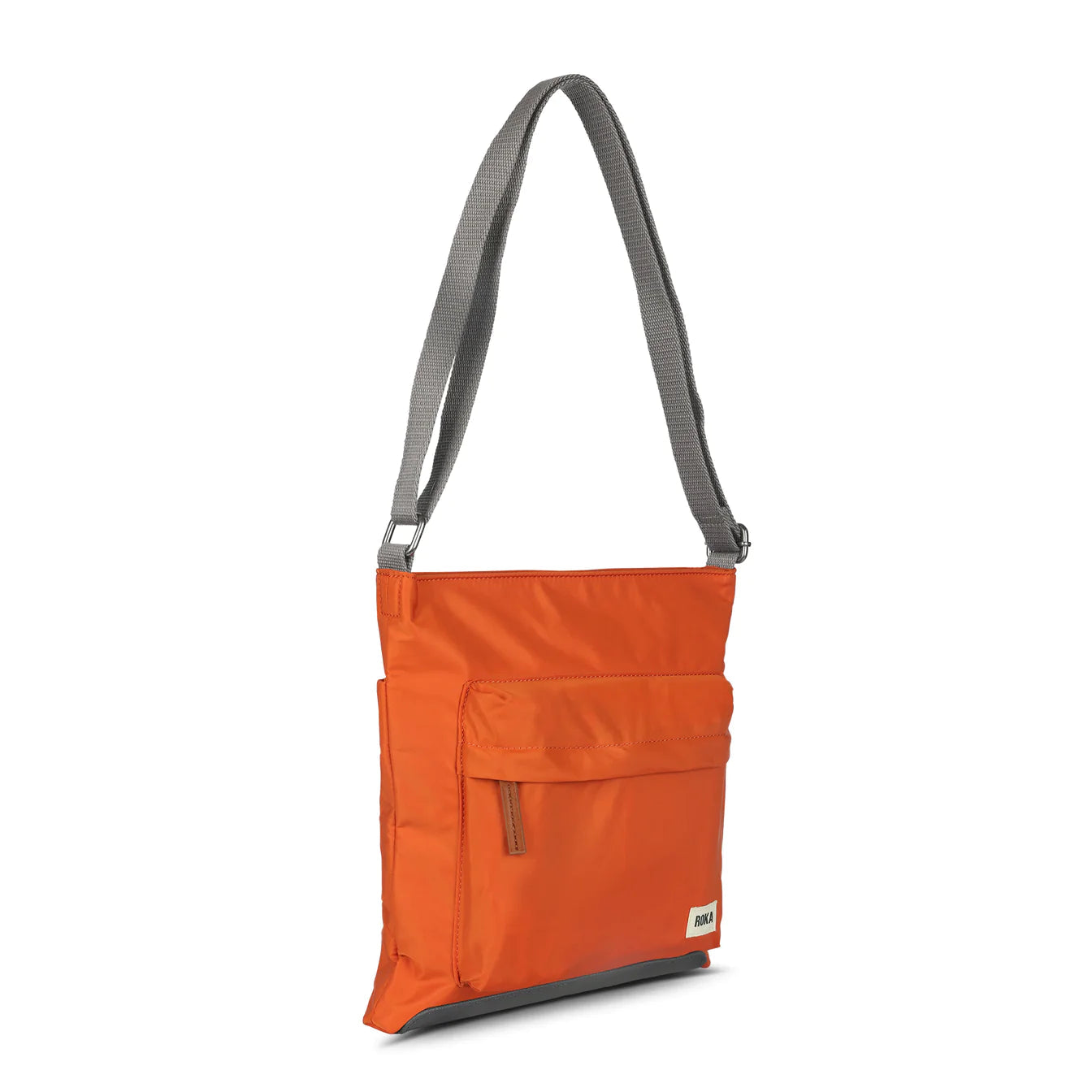 Burnt orange nylon crossbody bag with front flap pocket and gray straps