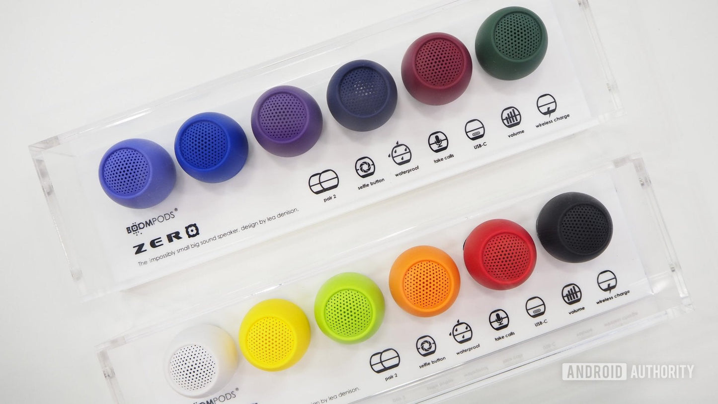 Mini wireless speaker display with multiple colored round speakers in clear packaging