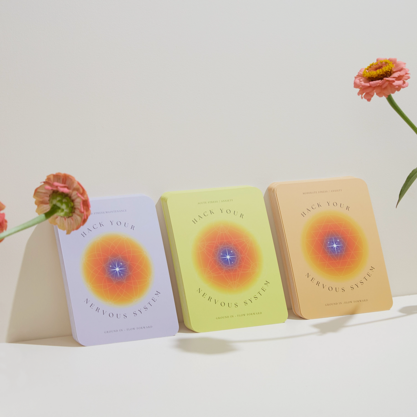 Three card fronts with colorful sunburst and blue center, arranged in a row.