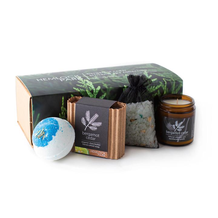 Spa gift set with bergamot cedar candle jar, blue bath bomb, bath soak pouch, and soap bar