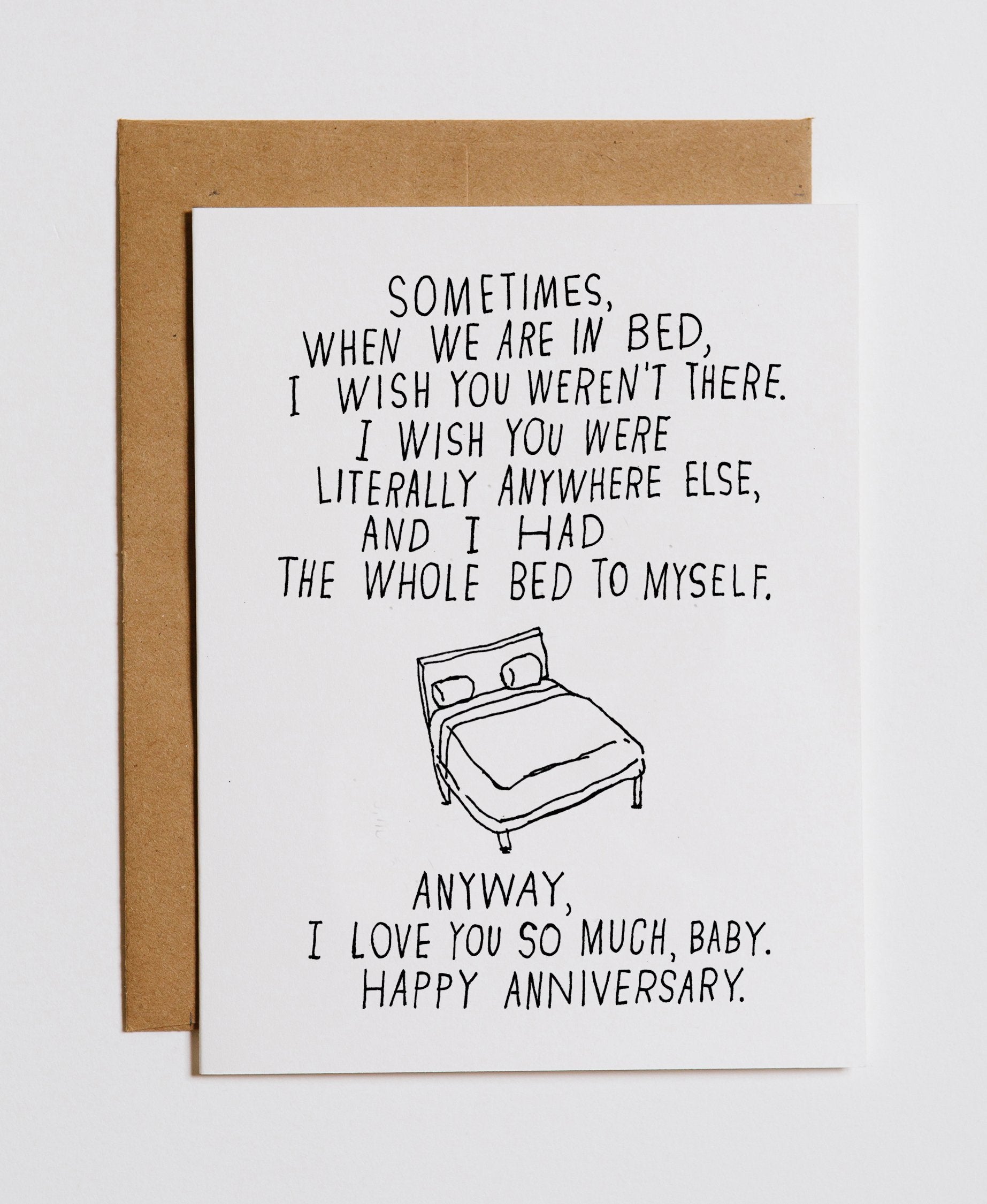 White anniversary greeting card with bed doodle and black love message, with brown envelope