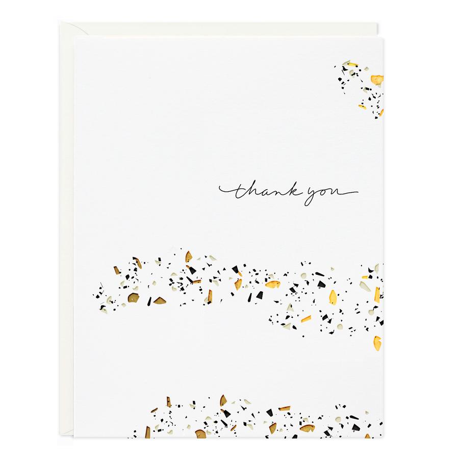 White thank-you greeting card with gold and black terrazzo speckles, cursive text.
