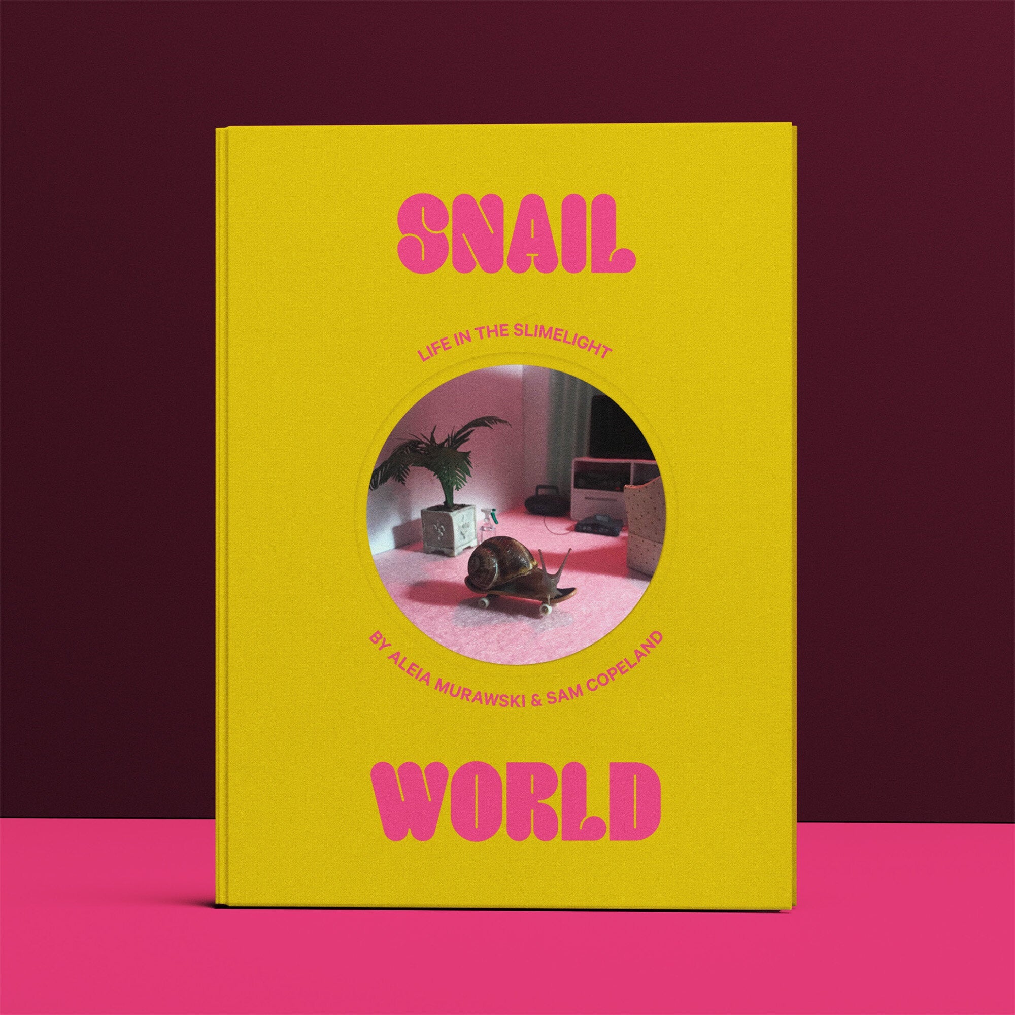 Yellow paperback book cover with pink "SNAIL WORLD" title and round window cutout