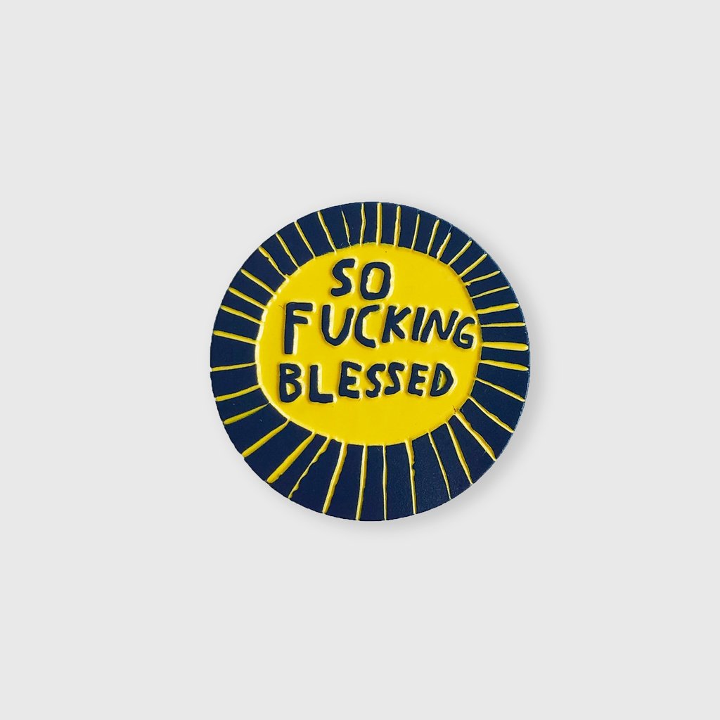 Round yellow and navy enamel pin with 'SO FUCKING BLESSED' text