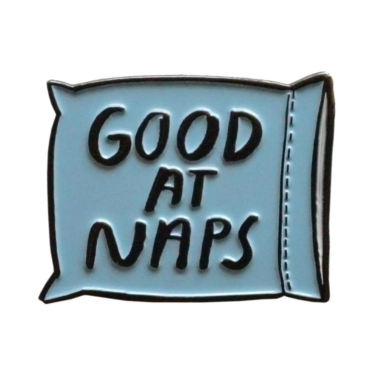 Blue enamel pin reading 'Good at Naps'