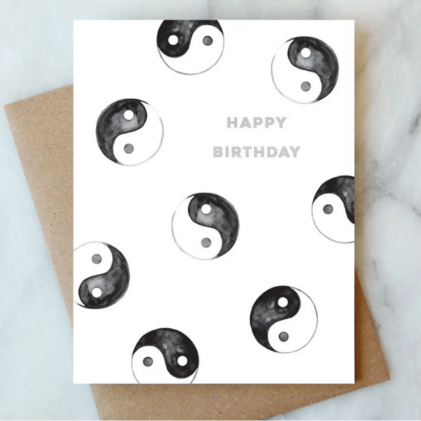 Happy Birthday greeting card with scattered yin-yang symbols, white with black icons