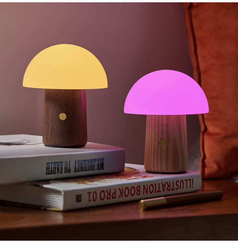 Mushroom table lamp with dark wood base and glowing yellow and pink shades