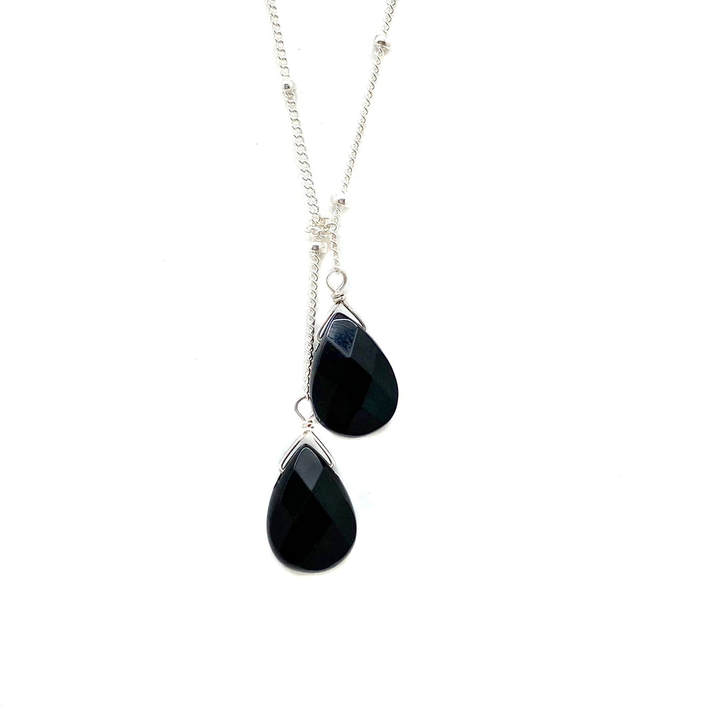 Sterling silver lariat necklace with two dark blue teardrop stones