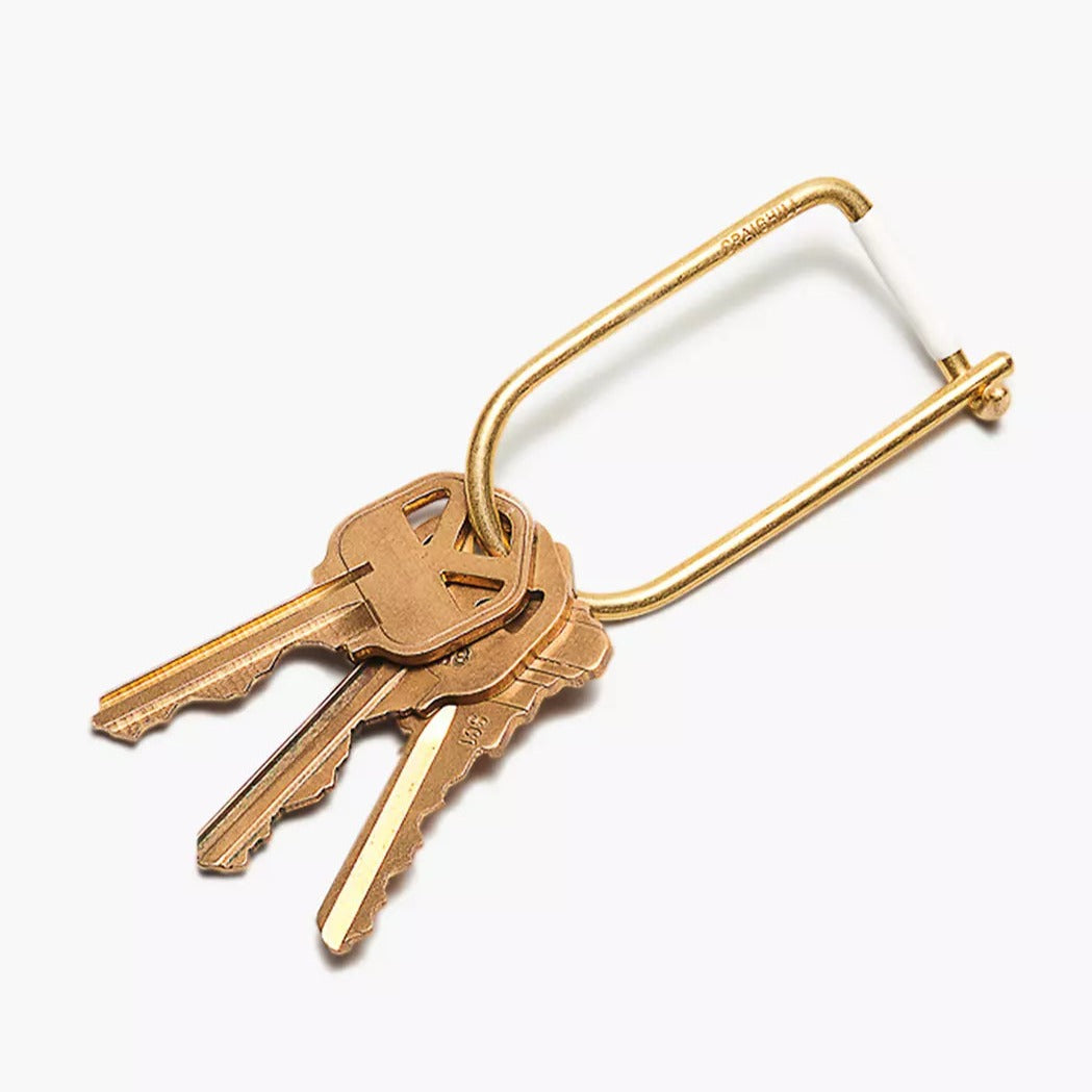 Gold keyring with four keys and a U-shaped loop
