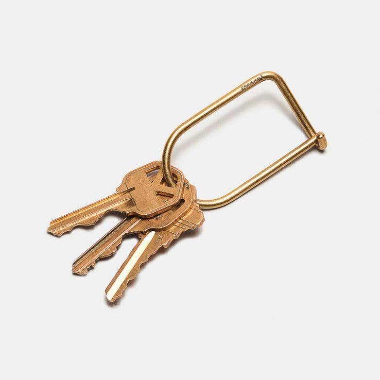 Gold keyring with four keys and a curved U-shaped loop