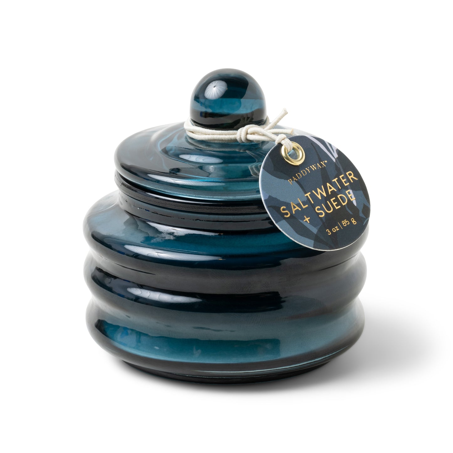 Beam candle in dark teal glossy glass jar with round lid and hanging tag