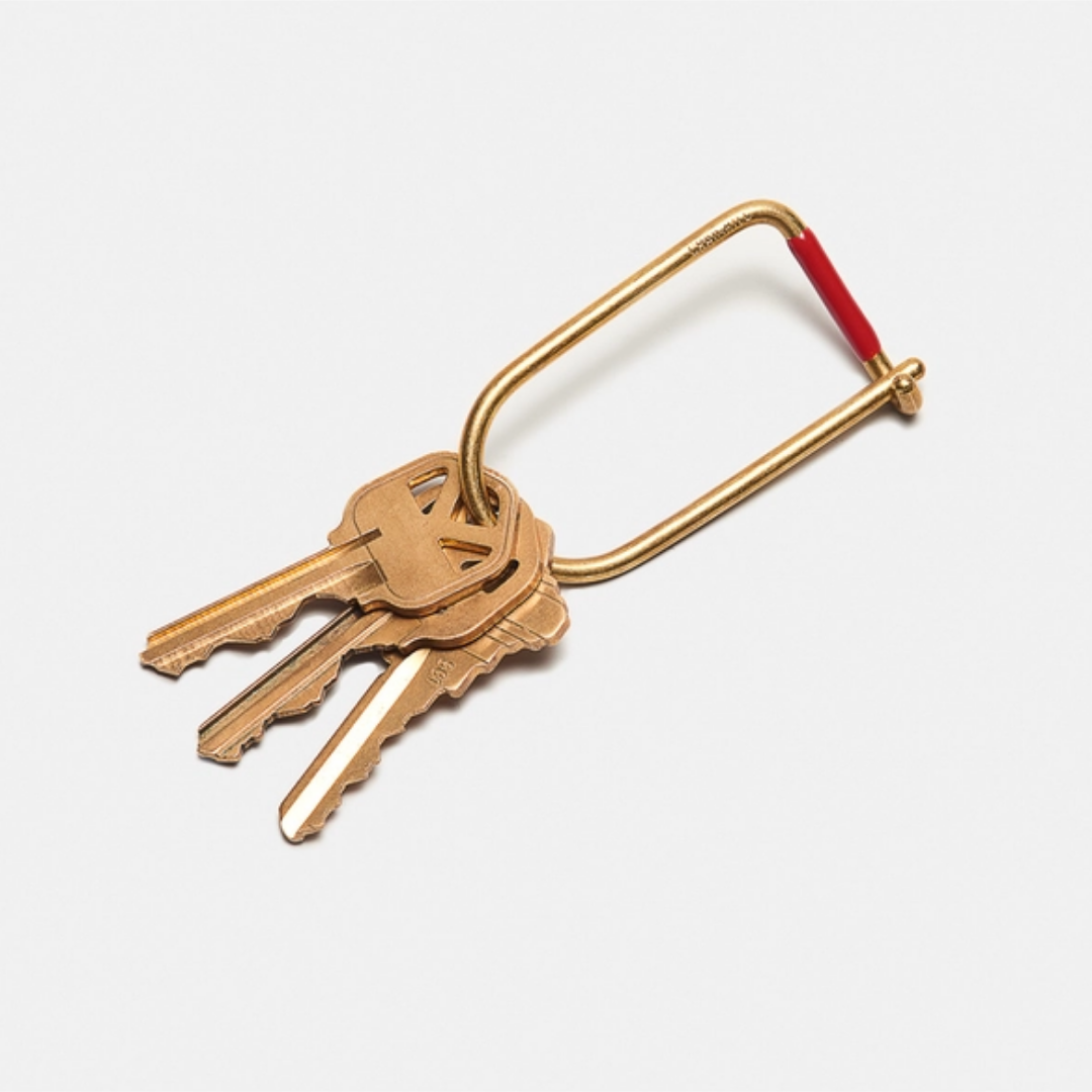Brass keyring with four keys and a U-shaped loop, red end cap